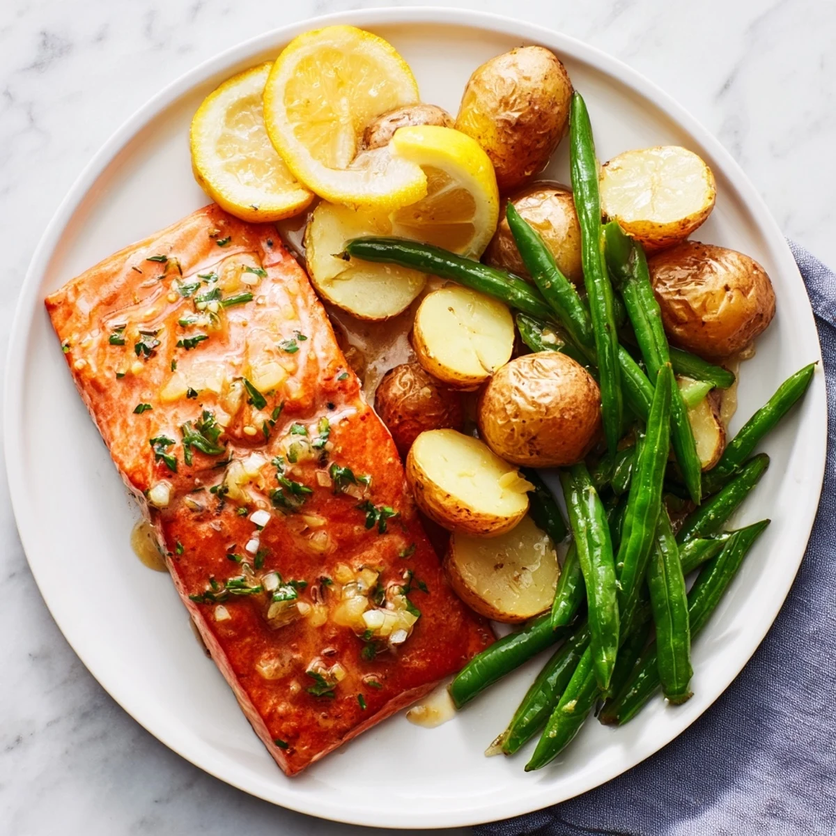 Golden-brown Lemon Herb Salmon & Potato sheet pan, with flaky salmon and roasted vegetables.