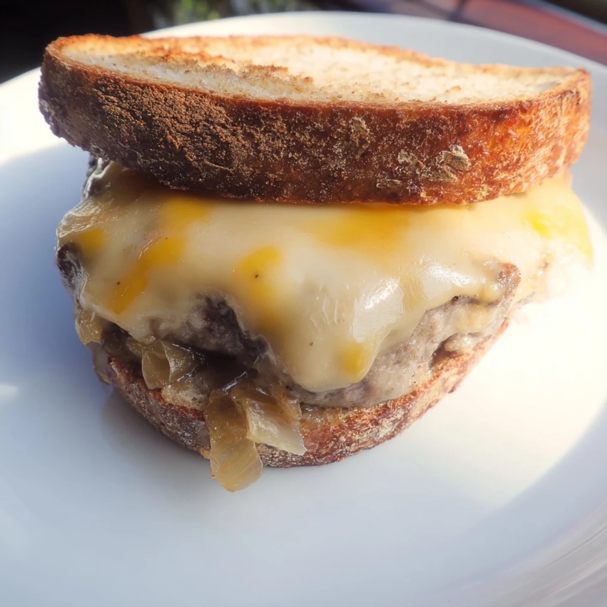 A close-up shot of a savory Patty Melt Skillet with onions and melted cheese on rye.