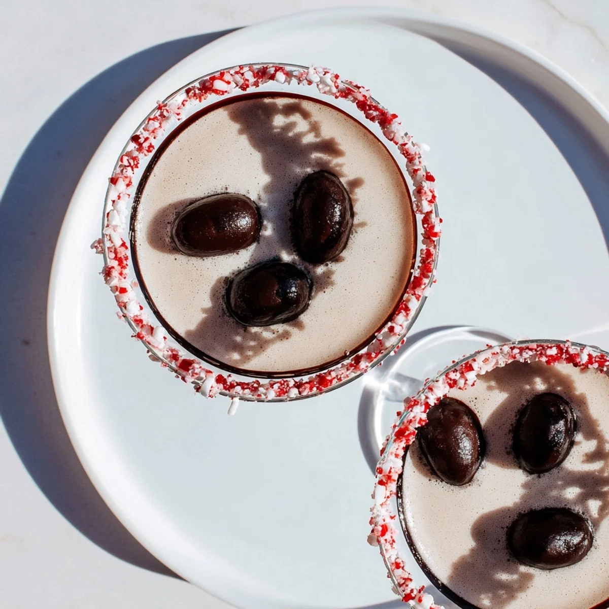 Creamy Peppermint Espresso Martini in a glass, with a chocolate-mint rim, ready to enjoy.
