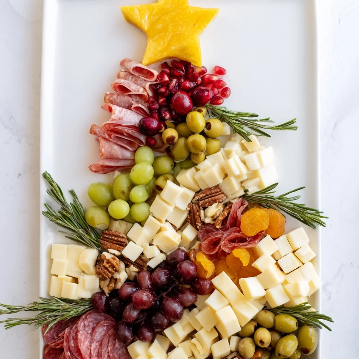 A visually appealing Christmas Tree Charcuterie Dream, with cheese, meat, and colorful grapes, ready to serve.