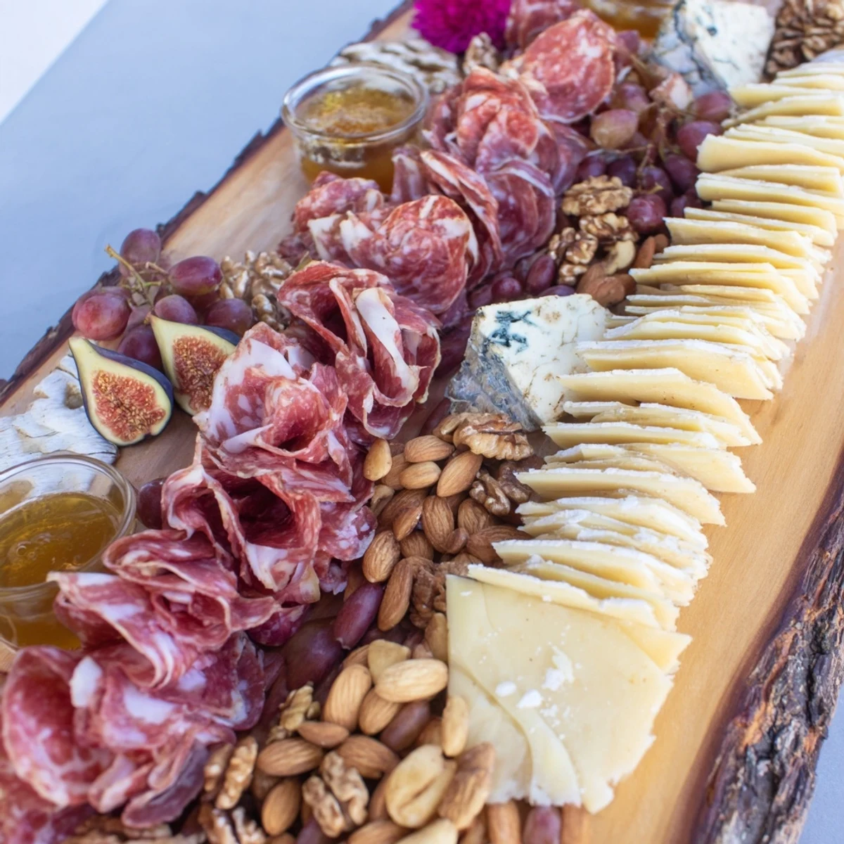See a beautifully arranged Majestic Venison Charcuterie Platter with salami, grapes, and nuts, perfect for entertaining.