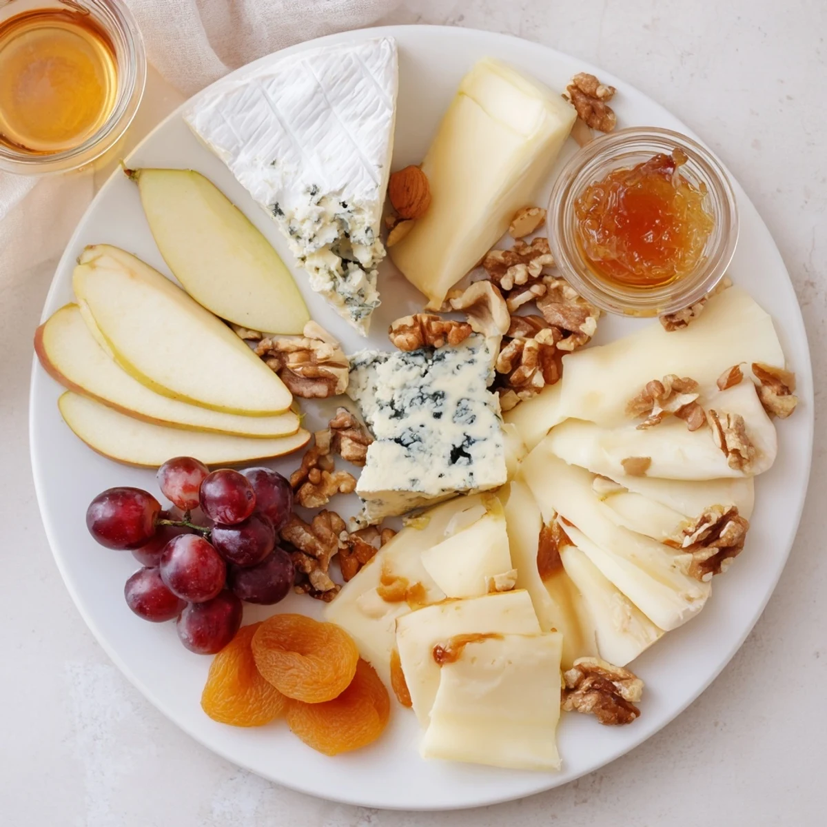 A beautifully arranged Cheese Platter Cœur Passion, overflowing with French cheeses and fresh fruit.