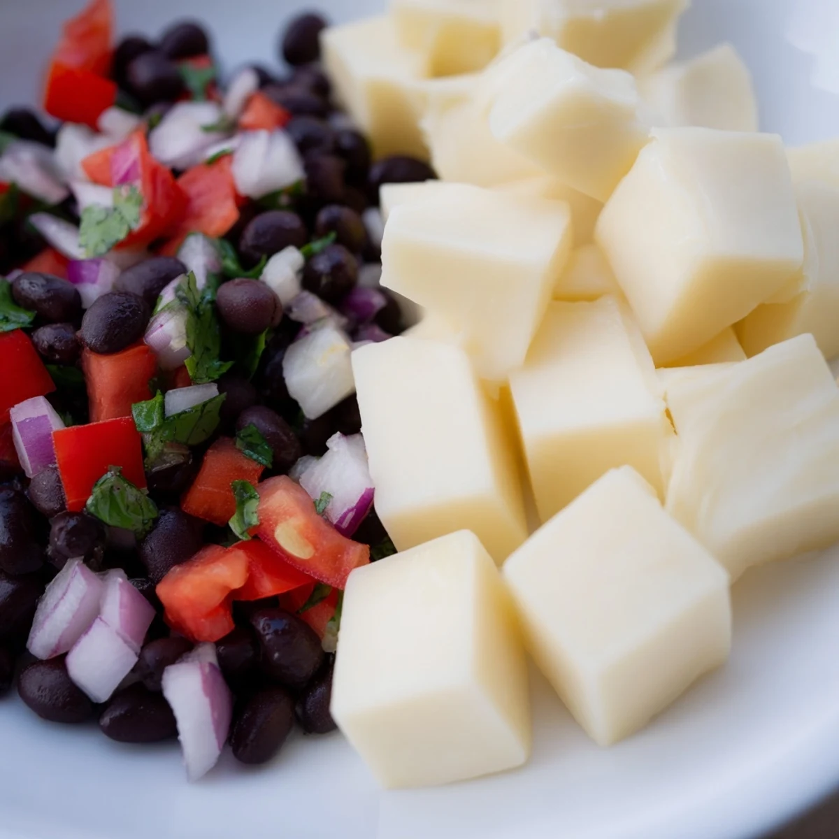 Close-up of spicy Pepper Jack Cubes appetizer, perfect with tangy black bean salsa for serving.