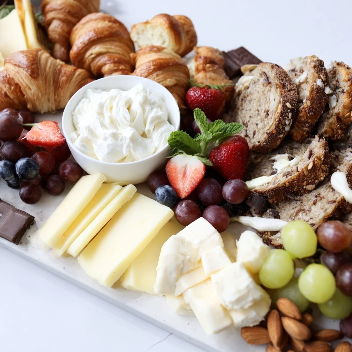 Gift Box Brunch Board Delight, overflowing with colorful fruits, cheeses, and mini pastries for sharing.