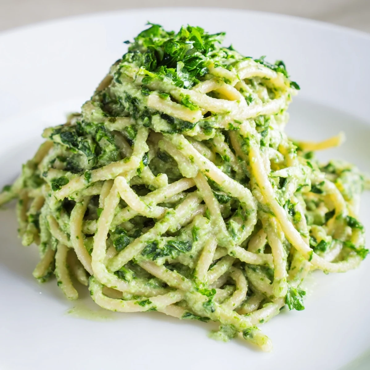 Vivid green goddess pasta sauce coating perfectly cooked pasta, ready to serve and enjoy.