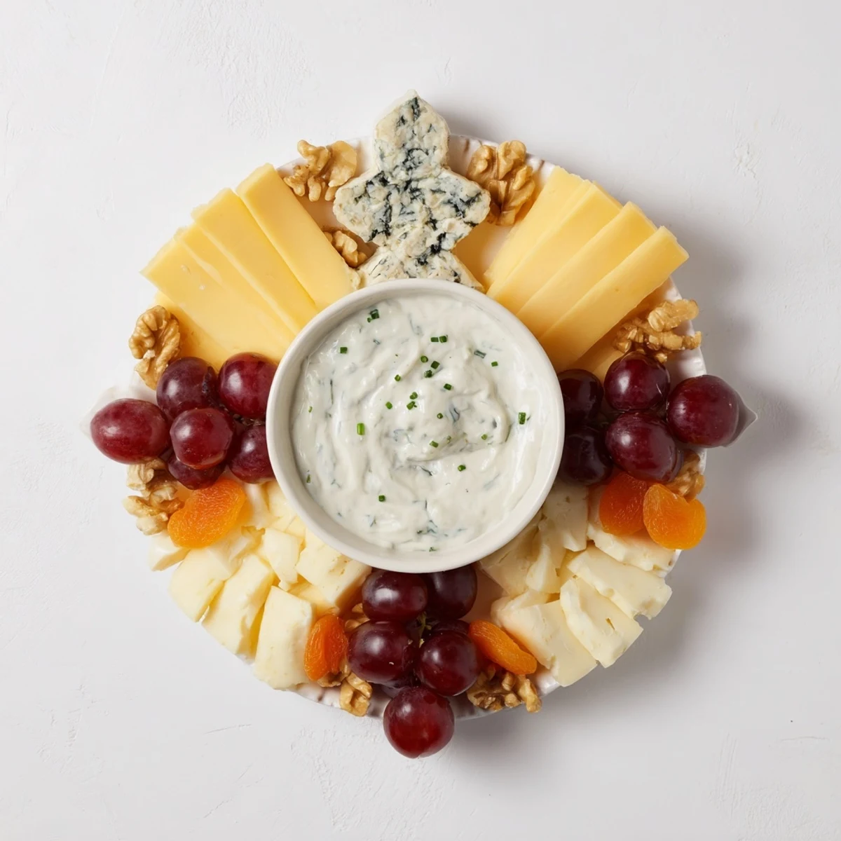 A stunning Celtic Cross Cheese Platter with assorted cheeses and vibrant grape clusters.