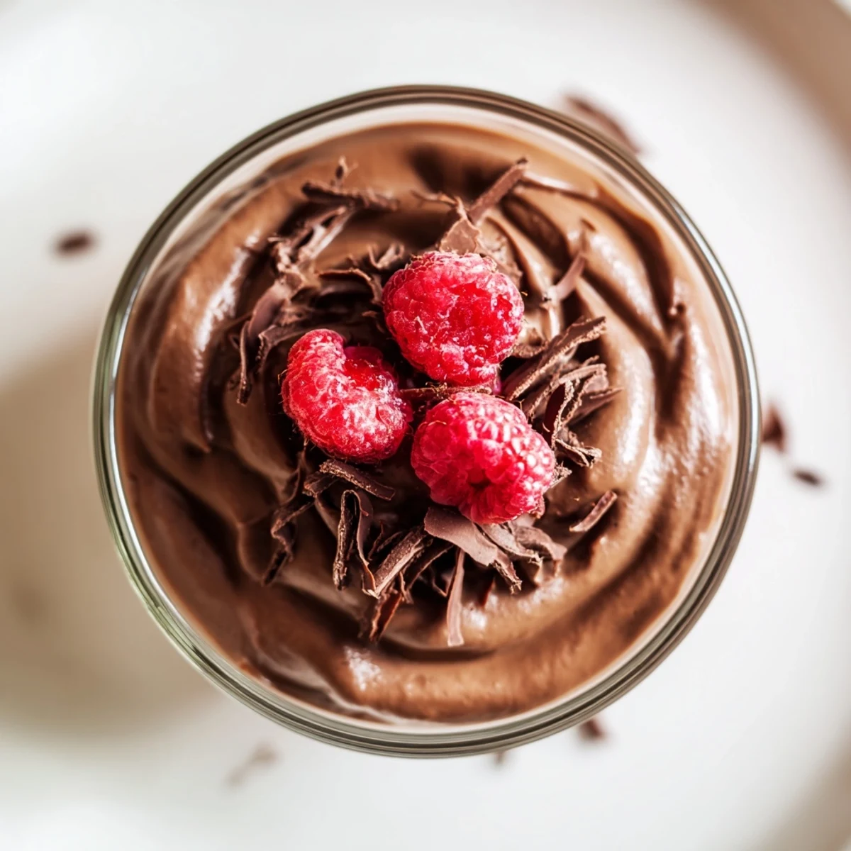 Smooth, decadent chocolate avocado mousse garnished with fresh berries ready to enjoy.