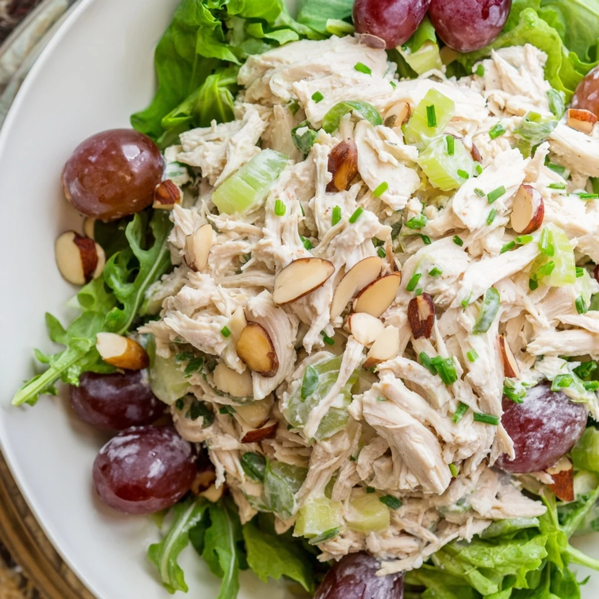 Bright image of creamy, crunchy Crispy Chicken Salad on a bed of fresh, vibrant salad greens.