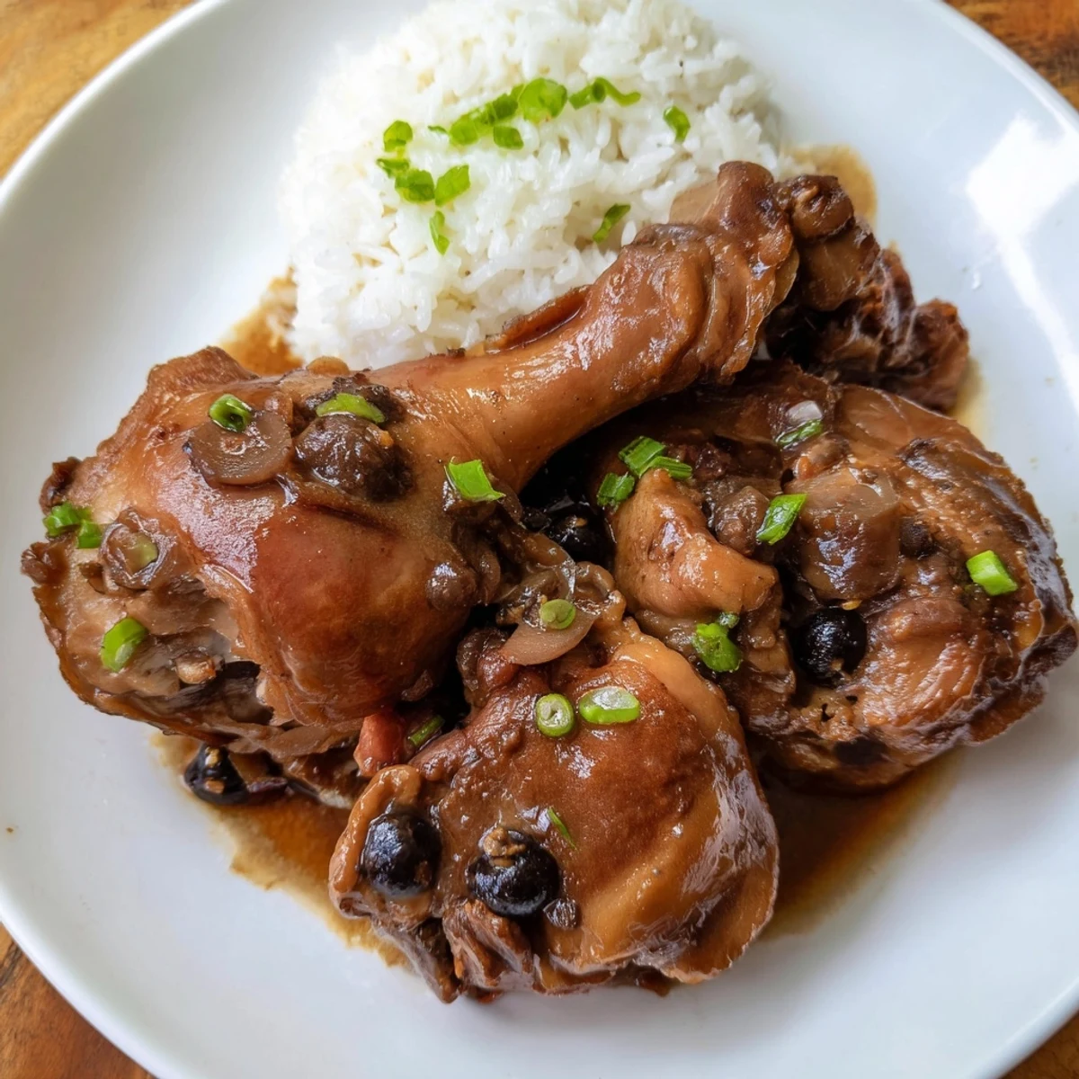 Tender Filipino Chicken Adobo with glistening sauce, perfect flavor served over fluffy steamed rice.