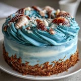 Moist vanilla Cancer Zodiac Cake frosted with creamy blue buttercream, adorned with.