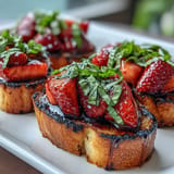 Colorful strawberry balsamic bruschetta atop grilled sourdough, a perfect summer appetizer.