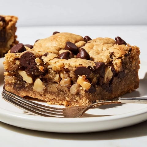 Gooey chocolate chip cookie bars fresh out of the oven, topped with melted chocolate.  