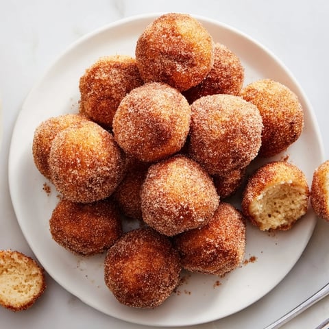 Light and fluffy cinnamon sugar donut holes dusted for a heavenly treat.  