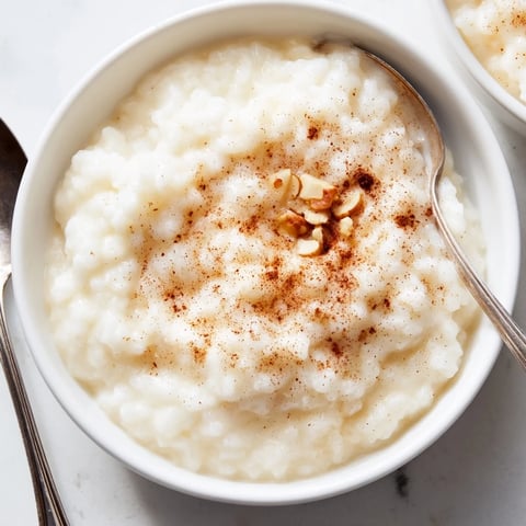 Creamy rice pudding with cinnamon, garnished with raisins and warm, comforting flavors.  