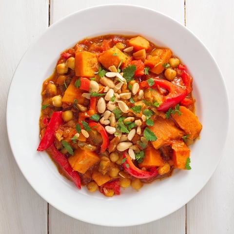 Golden Moroccan Chickpea & Sweet Potato Tagine, a vibrant, spiced stew with tender sweet potatoes.