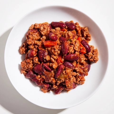 Steaming bowl of The Secret 4-Ingredient Chili, ready with optional toppings like sour cream!