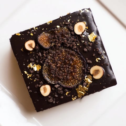 A close-up of The Midnight Mosaic shows a decadent dessert with figs, olives, and chocolate.