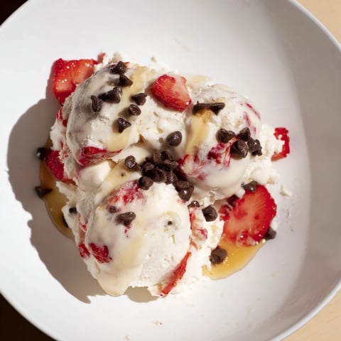 Smooth cottage cheese ice cream swirled with juicy strawberries, a delightful, creamy dessert.