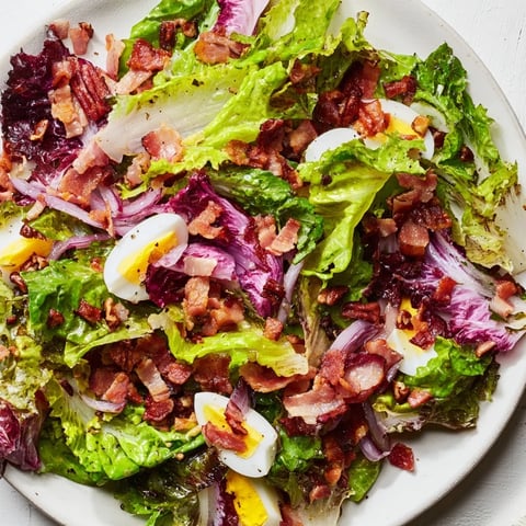 Vibrant Bitter Greens Salad with Warm Bacon Dressing, a delightful blend of fresh, wilted greens.