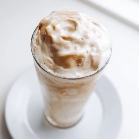 Fluffy Starbucks Cold Foam sits atop a chilled coffee, a creamy and sweet, vanilla-infused treat.