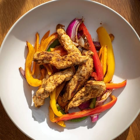 Enjoy easy Sheet-Pan Chicken Fajitas with tender chicken, vibrant veggies, and flavorful spices.