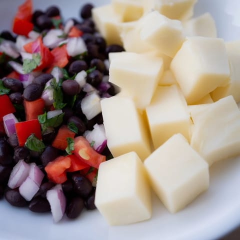 Close-up of spicy Pepper Jack Cubes appetizer, perfect with tangy black bean salsa for serving.