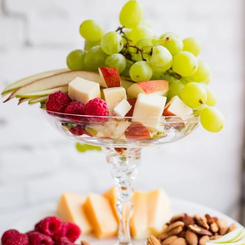 Festive Champagne Waterfall Board, featuring sliced brie, aged cheddar, perfect for a party.