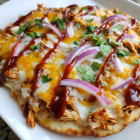 This homemade BBQ Chicken Flatbread showcases melty cheese, juicy chicken, and fresh cilantro sprinkled on top.