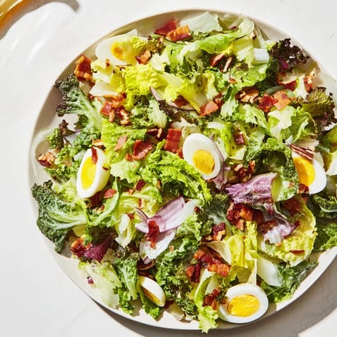 This appetizing Bitter Greens Salad with Warm Bacon Dressing features crisp bacon and a tangy vinaigrette.