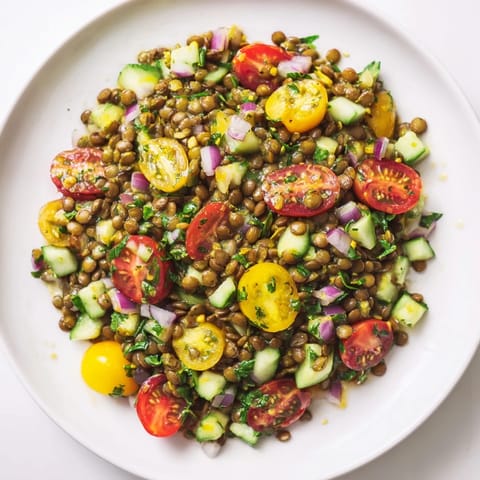 Fresh lentil salad bursting with color, drizzled with tangy vinaigrette, perfect for a light lunch.