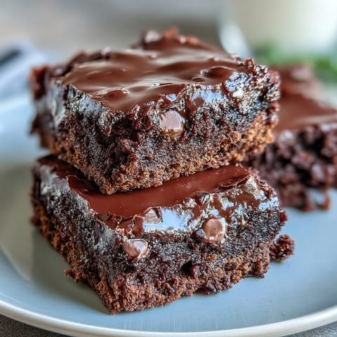 Decadent triple chocolate sourdough brownies with rich bittersweet and milk chocolate, topped with chocolate chips for extra indulgence.  