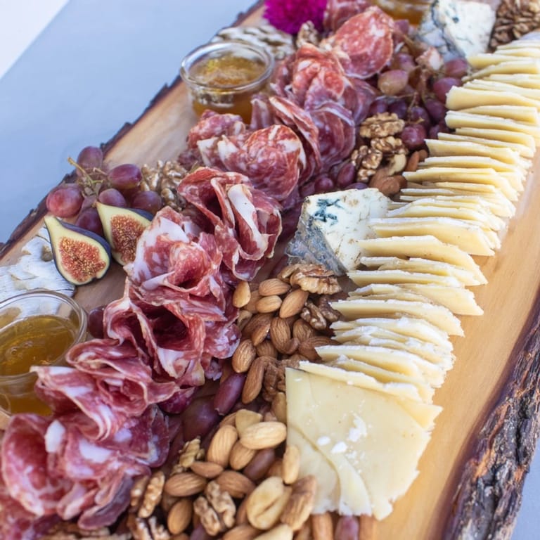 See a beautifully arranged Majestic Venison Charcuterie Platter with salami, grapes, and nuts, perfect for entertaining.