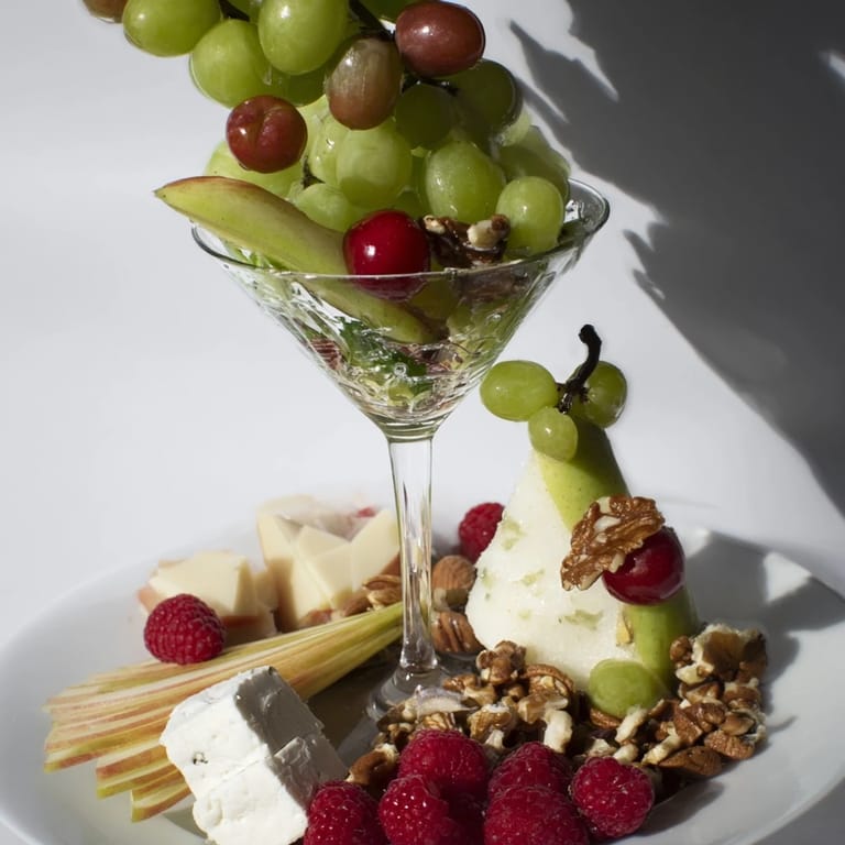 A luscious Champagne Waterfall Board, showcasing an assortment of fresh fruits, nuts, and crackers.
