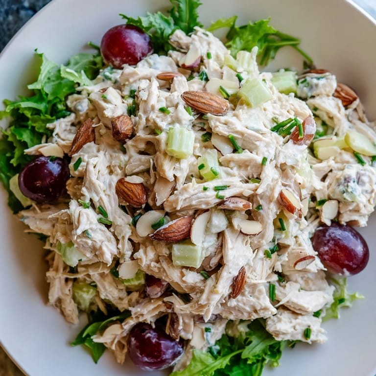 Close-up of a bowl filled with delightful Crispy Chicken Salad with juicy grapes and crisp celery.