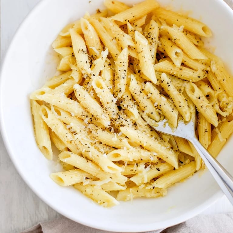 Quick-cooked fusilli pasta rests in a microwave-safe bowl with a spoon, a simple and convenient meal for busy days or small apartments.