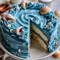 Cancer Zodiac Cake: ocean blue hues with shimmering edible shells.
